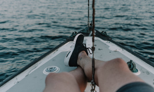 A person wearing boat shoes on a boat.